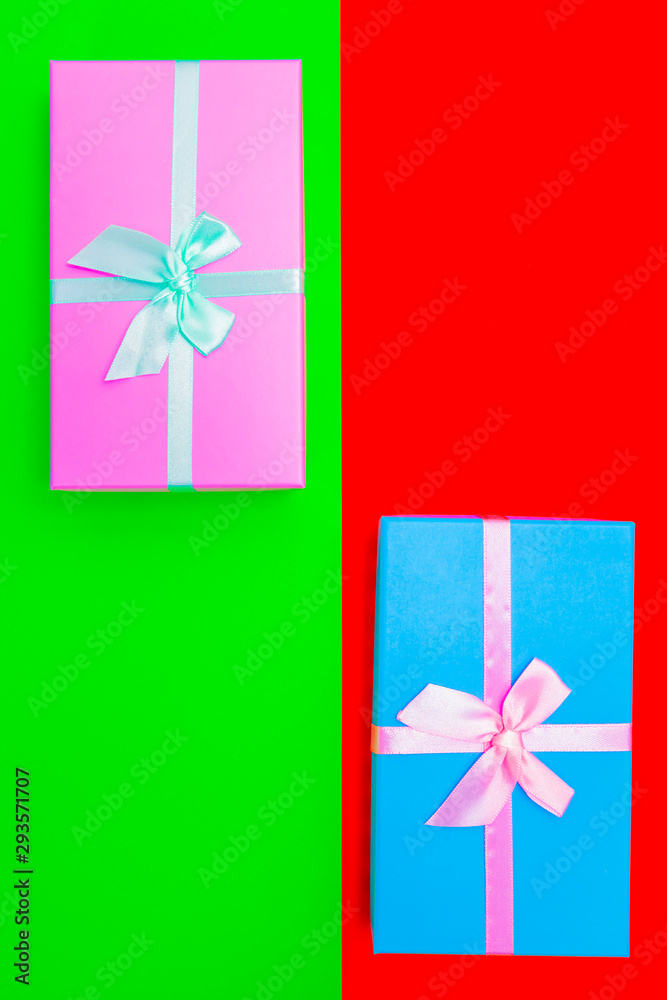 Aufkleber colored boxes with ribbons on a colorful background. view from above.