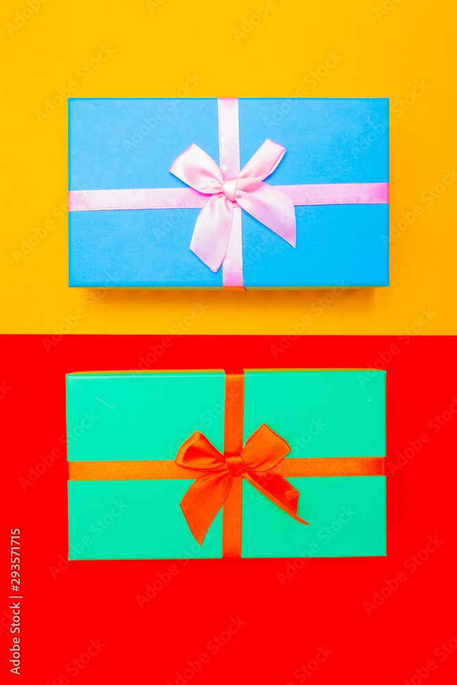 Aufkleber colored boxes with ribbons on a colorful background. view from above.