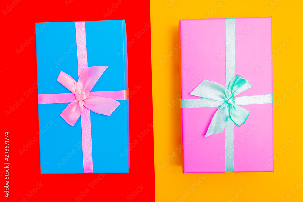 Aufkleber colored boxes with ribbons on a colorful background. view from above.