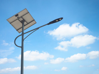 solar street light lamp post led with panel system and blue sky and white clouds using for background energy saving concept.