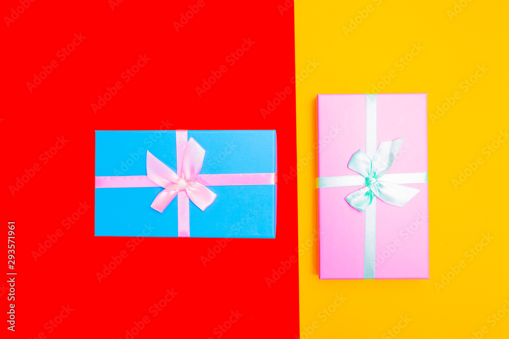 Aufkleber colored boxes with ribbons on a colorful background. view from above.