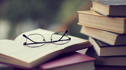 pile of old books lie on the table. home library. concept of vacation from gadgets in nature