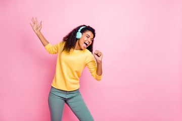 I'll grow up and become star person in music world in the future. Photo of talented gifted with strong loud voice teenager teen girl holding mic singing enjoying melody isolated pink background