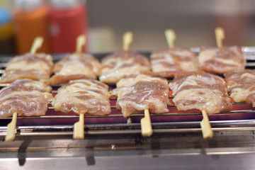 Grilled pork placed on the grill.