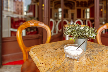 View of an empty table in a restaurant in the city center. Sukiennice hall. Cracow, Poland. Downtown early morning. Main square in the historic city. Vacation in a royal town.