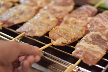 People who are grilling pork