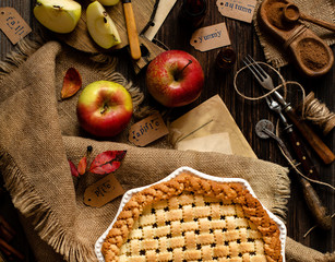 overhead shot of homemade thanksgiving warm baked apple lattice pie crust on sackcloth on rustic...