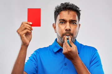 sport, caution, game and football concept - indian referee whistling and showing red penalty card