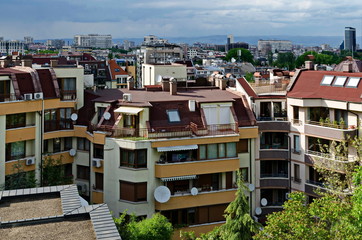 Fototapeta na wymiar Residential neighborhood with new modern houses against the backdrop of a cityscape in the Bulgarian capital Sofia, Bulgaria 