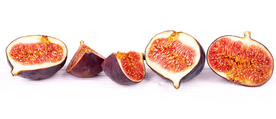 Row of ripe figs on a white background