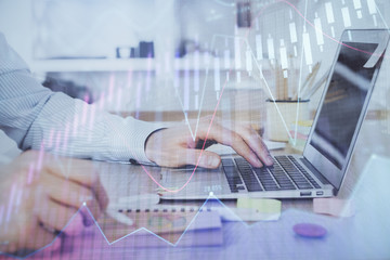 Multi exposure of stock market chart with man working on computer on background. Concept of financial analysis.