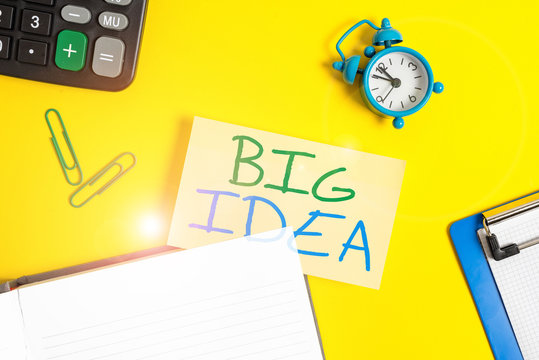 Text sign showing Big Idea. Business photo showcasing Having great creative innovation solution or way of thinking Empty orange paper with copy space on the yellow table