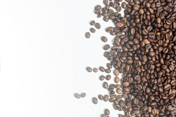 coffee beans are scattered on a white background. space for text. photon image