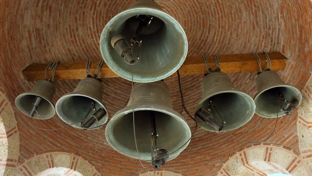 Old greek belfry with six bell on church. Orthodox Meteora monasteries. Greece. 4K