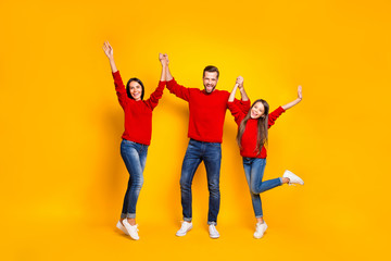 Fototapeta na wymiar Full length body size photo of rejoicing screaming cheerful positive friendly family loving each other with emotional facial red sweaters expression isolated over vivid color yellow background
