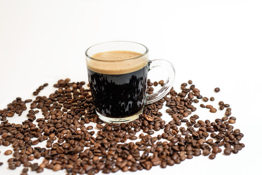 a Cup of fresh coffee stands on coffee beans on a white background . space for text. background image