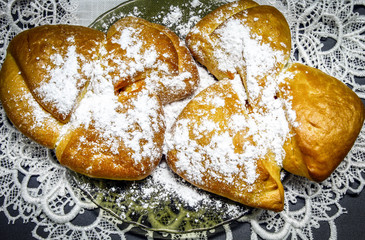 Two rolls with Apple jam and powdered sugar on a plate