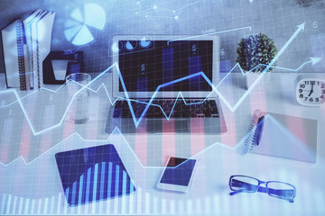 Financial market graph hologram and personal computer on background. Double exposure. Concept of forex.