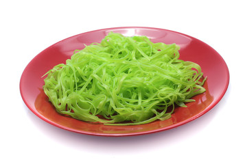 green noodles on dish isolated on white background