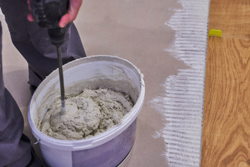 close-up of handyman placing tile spacer. Placing the floor tiles. Home improvement