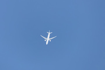 A small passenger plane flies high in the sky