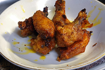 Delicious fried chicken wings on white plate.