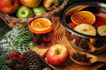 Christmas drink mulled wine, fruit and spices on a wooden table