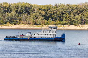 River tug without cargo floating on river
