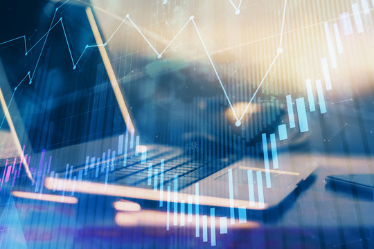Financial graph colorful drawing and table with computer on background. Double exposure. Concept of international markets.