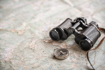 trekking map for explorers and hand, binocular, compass and analog camera for travellers,...