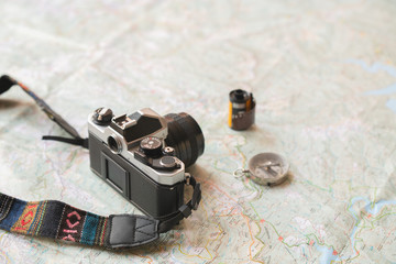 trekking map for explorers and hand, binocular, compass and analog camera for travellers, photographers and nomad lifestyle