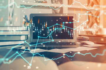 Financial graph colorful drawing and table with computer on background. Double exposure. Concept of international markets.