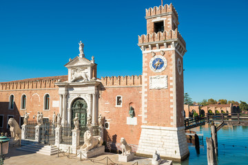Fototapeta na wymiar Entrance to Venetian Arsenal with clock and towers. Venice, Italy