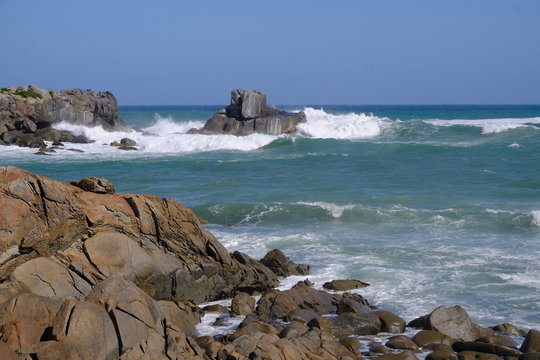 Rocks and stormy sea at Cozy Nook Bay, Southland, New Zealand