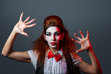 Red-haired girl with creative make-up and hairstyle for a Halloween party.