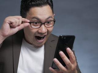 Shocked Happy Man Looking at Smart Phone