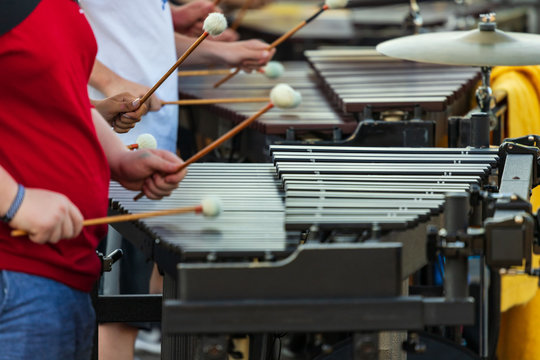 flashing mallets of the sideline percussionists at rehearsal