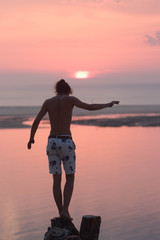 Fototapeta premium silhouette of a man running on the beach at sunset (Dune Du Pyla, France)