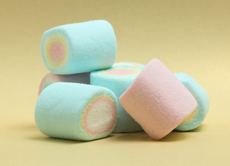 colorful marshmallows candy  on yellow background