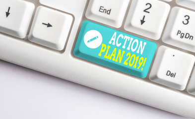 Handwriting text Action Plan 2019. Conceptual photo proposed strategy or course of actions for current year White pc keyboard with empty note paper above white background key copy space