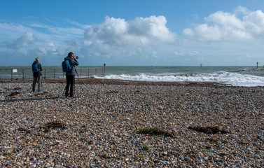 Photographers capturing a seascape on the south coast of England.