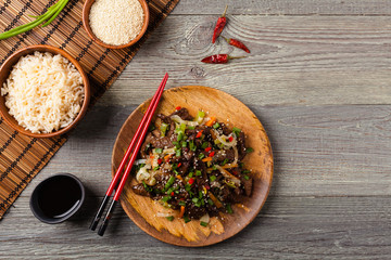 Traditional Korean Bulgogi dish.  Thinly cut, grilled beef, served with rice and vegetables.