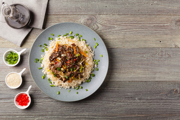 Traditional Korean Bulgogi dish.  Thinly cut, grilled beef, served with rice and vegetables.