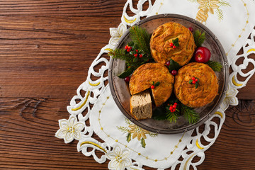 Small, baked patties in Christmas retro styling. Top view. Natural wooden background.