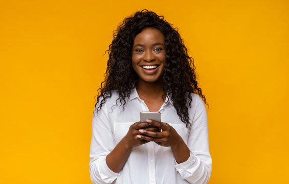 Happy african american girl using her smartphone