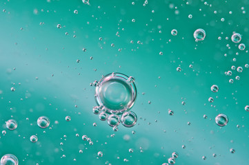 Bubbles of oxygen or air in liquid. Macro. Oxygen bubbles in water, turquoise background, concept...
