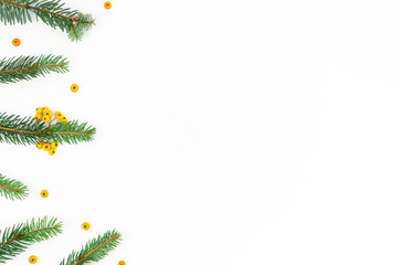 Flat lay banner with yellow berries, branches fur tree on whitebackground. Decorative christmas frame mockup with place for text
