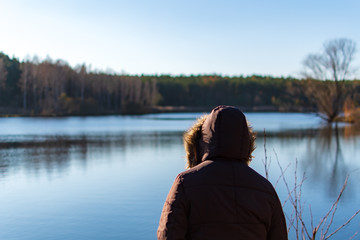 Woman overviewing a lake while autumn