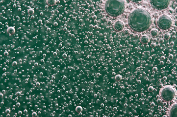 Bubbles of oxygen or air in liquid. Macro. Oxygen bubbles in water, turquoise background, concept...
