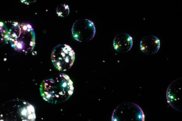 Many soap bubbles on a dark background